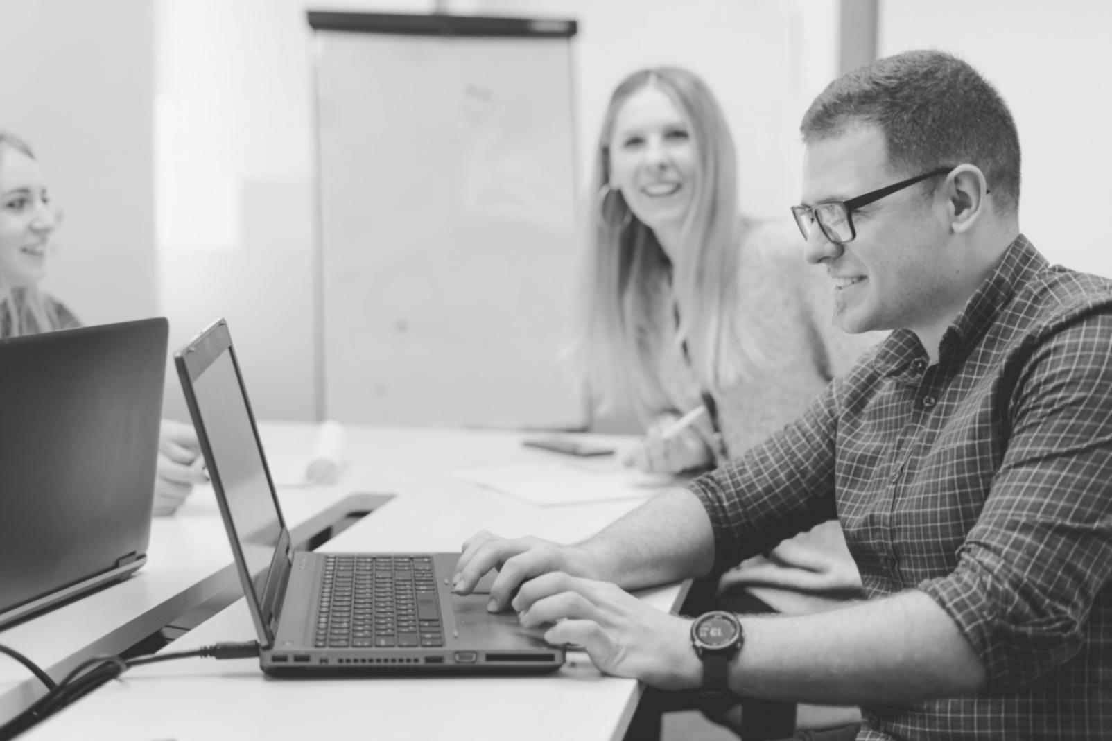 Financial analyst reviewing complex data models on multiple screens
